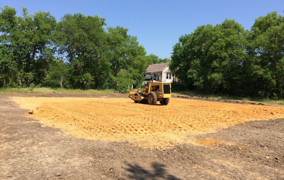 Gravel processing machine creating a large mound of sand