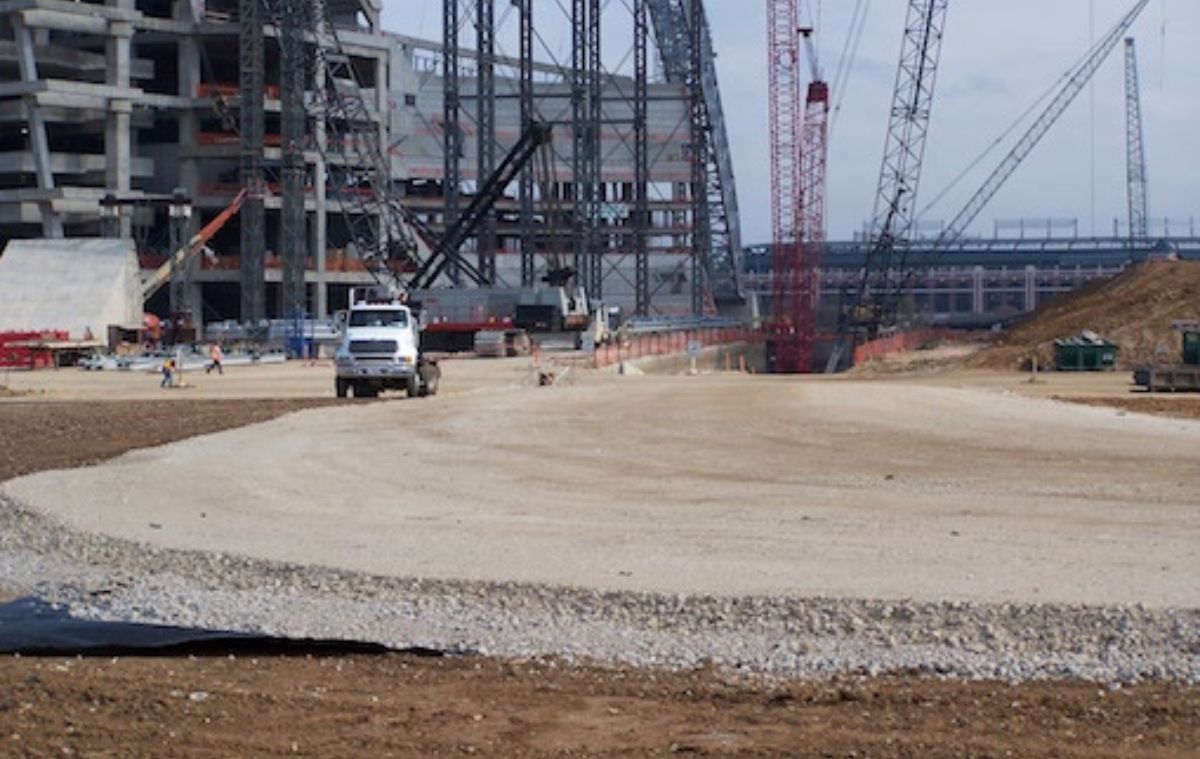 Large construction site with cranes and trucks